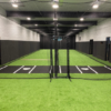 black batting mat on green turf