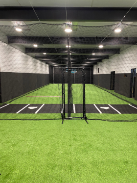 black batting mat on green turf